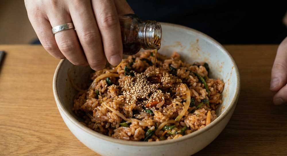 Finishing with a drop of sesame oil and a sprinkle of sesame seeds